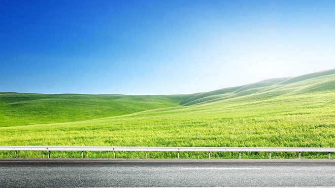 Blue sky, white clouds and grass next to the highway PPT background picture